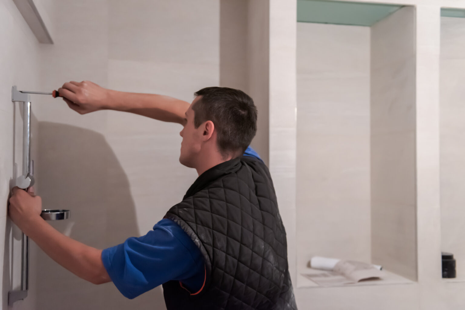 professional plumber working in a bathroom